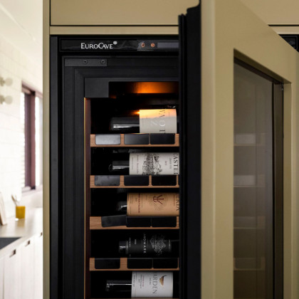 Optimisation d'espace avec une cave à vin EuroCave dans un mobilier contemporain coloré.